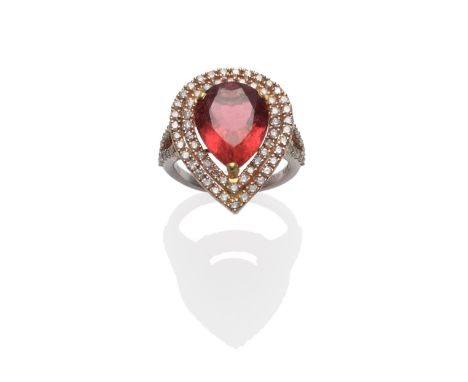 A 14 Carat Gold Tourmaline and Diamond Cluster Ring, the pink pear cut tourmaline within a double border of round brilliant c