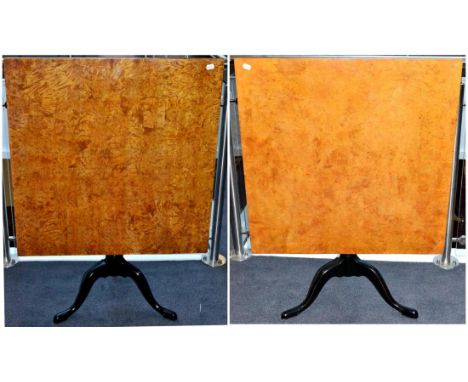 A Pair of Swedish Birch Flip-Top Tripod Tables, raised on ebonised vasiform turned supports with three cabriole legs, 87cm by