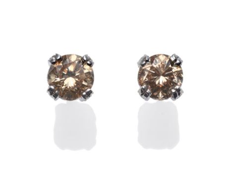 A Pair of Cognac Diamond Earrings, each round brilliant cut diamond in a white double claw setting, which is inset with small