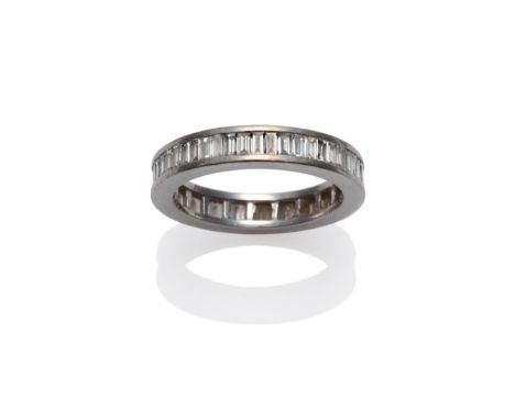 A Diamond Full Eternity Ring, baguette cut diamonds channel set in a white flat sided mount, total estimated diamond weight 1