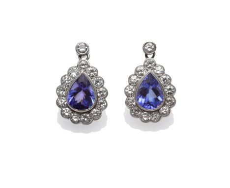 A Pair of Tanzanite and Diamond Earrings, a pear cut tanzanite within a border of round brilliant cut diamonds, suspended fro