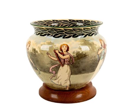 Large porcelain jardiniere decorated with an illustration of dancing ladies with a green foliage along border. Handwritten D 