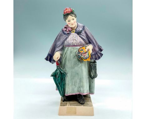 Glazed earthenware modeled as an elderly lady wearing a purple and blue jacket, holding a green umbrella. Marked Charles Vyse