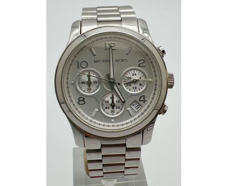 A Michael Kors men's chronograph MK5076 wristwatch. Stainless steel strap and case. White face with silver tone and luminous 