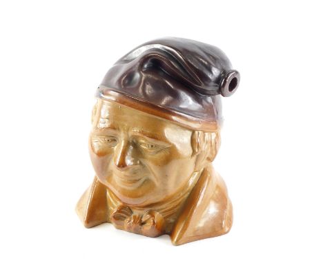 A 19thC stoneware flask, modelled in the form of a head of Tam O'Shanter, 26cm high. 