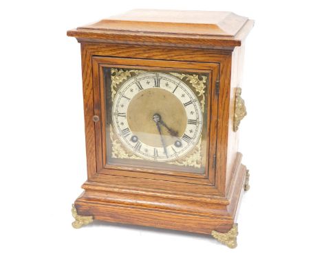 A 19thC oak mantel clock, with a rectangular brass dial with cherub spandrels and a silvered chapter ring with Roman numeric 