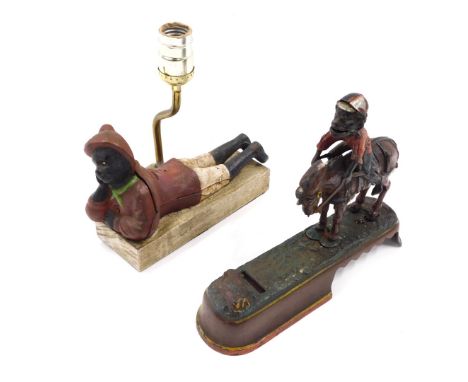 A cold painted cast metal money box, modelled in the form of a boy jumping from a horse, and a similar money box converted to