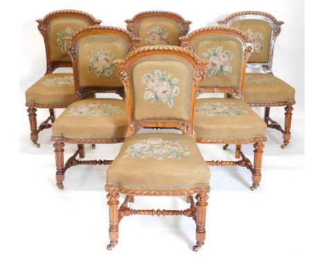 A set of fourteen Victorian elm and burr elm dining chairs, each with an arched gadrooned back with moulded leaf carved suppo