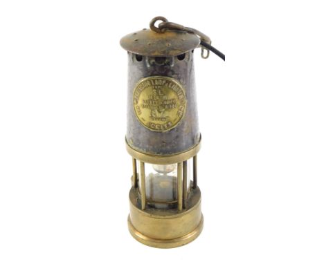 A Protector Lamp and Lighting Company mining lamp, numbered 87, bearing crest in carry hook, converted to electricity, 23cm h