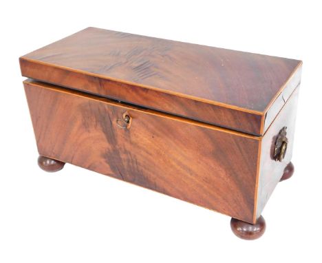 A 19thC mahogany tea caddy, of rectangular form, with a fitted cupboard and bowl interior, with brass swing handles, on bun f
