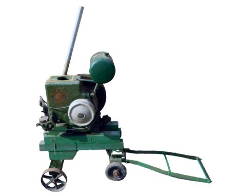 A Ruston Hornsby stationary engine on wooden trolley base, green painted, number 203642, 92cm high, 71cm wide. 