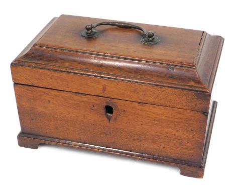 A George III mahogany tea caddy, the canted hinged lid with a brass handle enclosing vacant interior, 22cm wide. 