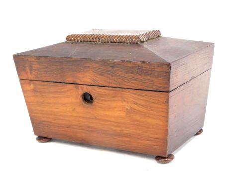 An early Victorian rosewood sarcophagus shaped tea caddy, the hinged lid enclosing two lidded divisions, on bun feet, 20cm wi