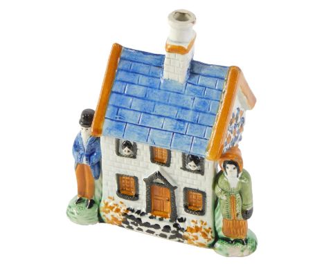 A 19thC Prattware money box, modelled as a cottage, with two figures, 15cm high, 11cm wide, 7cm deep. (AF) 