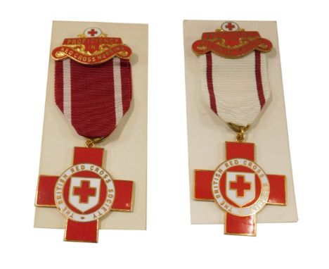 A British Red Cross Society enamel nurse's badge, and a first aid Red Cross badge, boxed. (2)