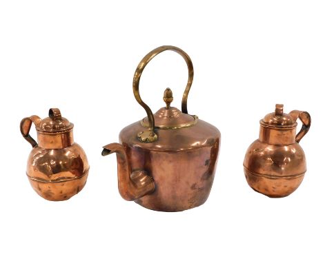 A Victorian copper kettle, and two copper Army and Navy Jersey type cream jugs. 
