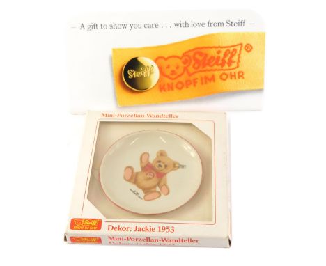 A Steiff small collectors plate Jackie 1953, and a white Perspex Steiff advertising plaque. 