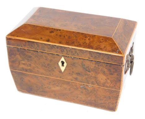 A Victorian yew sarcophagus shaped tea caddy, the hinged lid enclosing two lidded divisions flanked by cast brass handles, on
