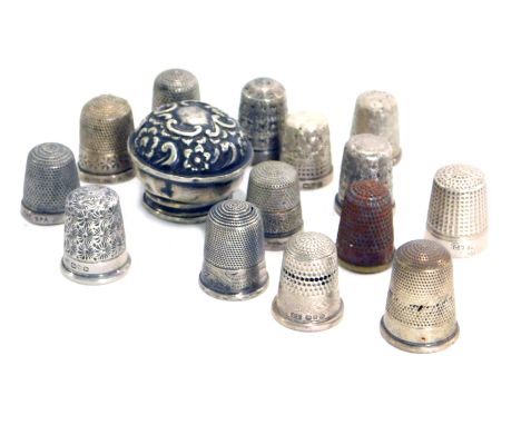 A collection of 20thC silver thimbles, and a silver and cork topped bottle lid, 2.50oz. 