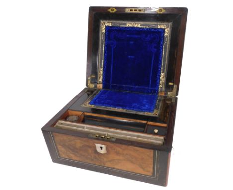 A Victorian walnut and ebonised writing slope, the rectangular top with vacant mother of pearl cartouche enclosing a fitted i