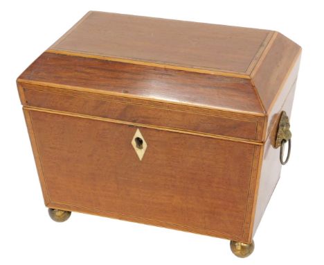 An early 19thC partridge wood tea caddy, the hinged lid enclosing two lidded divisions, on ball feet, 18cm wide. 