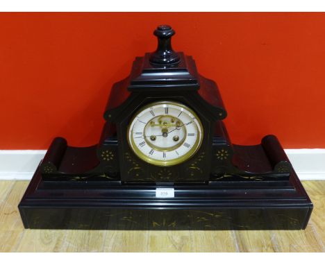 A 19th Century black slate mantle clock, the circular dial with Roman numerals, complete with key, 