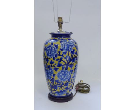 A blue floral patterned baluster table lamp base, on hardwood stand, 40cm high