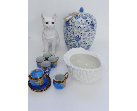 A contemporary blue and white vase and cover together with a Portuguese pottery cat figure, white glazed shell planter and a 