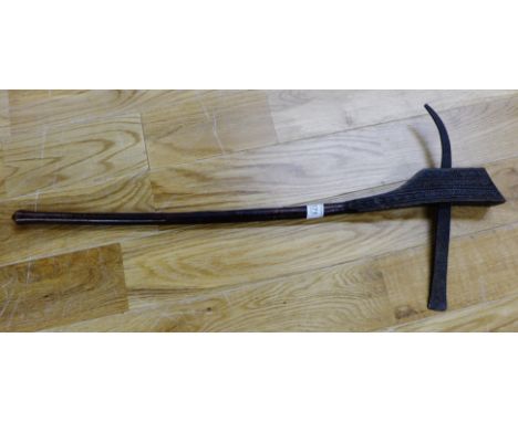 An Eastern carved hardwood and steel narrow axe, 64cm long 
