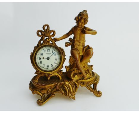 Newhaven Clock Co. of New York, rococo style mantle clock, the circular enamel dial encased in a ribbon tied gilded metal sur