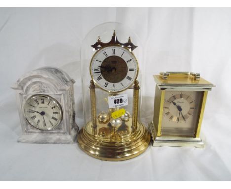 A glass domed mantle clock by Acctim, a Lincoln carriage clock and a mantle clock marked Park Lane  to the dial (3)