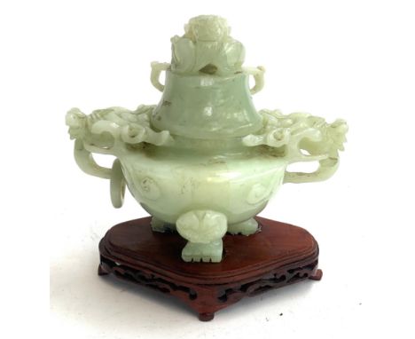 A Chinese carved jade tripod censer (af), 12cmH, on an unassociated pierced carved hardwood base 