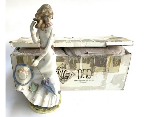 An Nao by Lladro figurine, girl with umbrella and blown away hat, 41cmH, with original box 