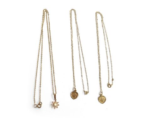 Three fine 9ct gold necklaces, two with St. Christopher pendants, the other with a floral pendant set with a seed pearl, appr