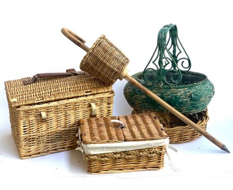 A number of wicker baskets, together with a foraging stick 