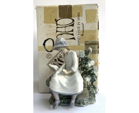 An Nao by Lladro figurine of a seated girl and a dove, 21.5cmH, with original box 