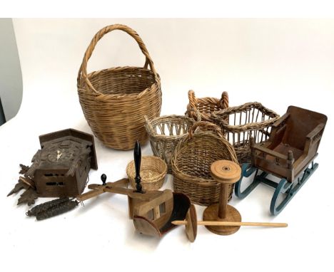 A mixed lot to include stereoscopic viewer, various wicker baskets, cuckoo clock (af), toy sled etc 