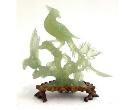 A Chinese carved jade figure group of birds on a branch on a carved hardwood base, 26.5cmH 