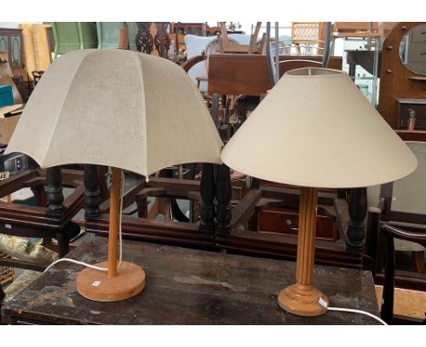 A wooden table lamp, with double fitting and umbrella shade; together with one other 