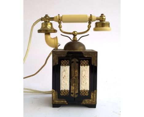 A vintage rotary telephone in the form of a black lacquered Chinese tabletop cabinet, 30cmH 