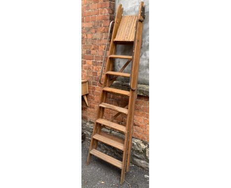 A seven run wooden folding step ladder 