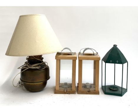 A pair of modern candle lanterns, a brass oil lamp (converted) and one other 