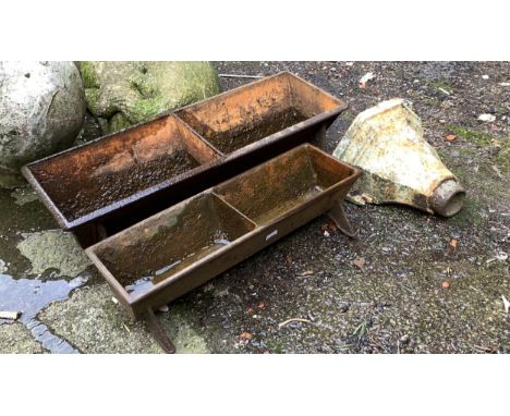 Two cast iron feed troughs, each divided, 59cm and 48cm long; together with a cast iron down pipe hopper 