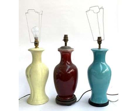 Three ceramic table lamps, the tallest 49cmH to the top of fitting, together with two shades 