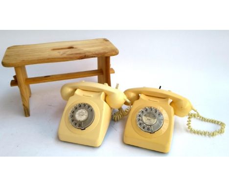 Two rotary telephones with labels for Luton and Bridport, together with a small pine stool, 21.5cmH 