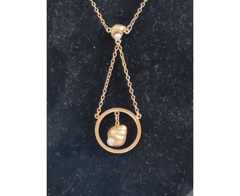 9ct gold fine chain and ring pendant with shell drop with mounted seed pearls, 2.7g including pearl.