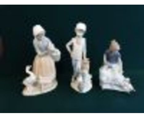 A pair of Lladro/Nao figurines Girl with puppies and Boy and his dog together with a Lladro figure of a farm girl and geese.