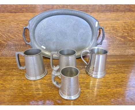 A Battle Axe hammered pewter tray and 4 pewter tankards.