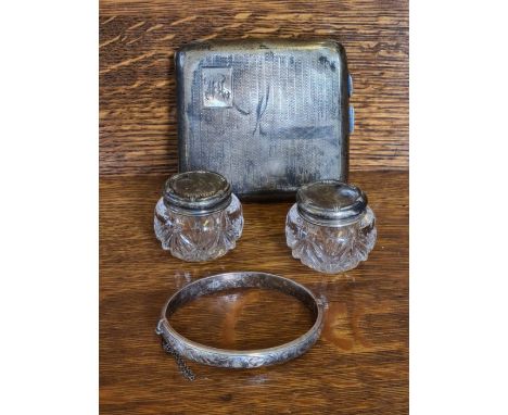 Silver engine turned cigarette case, chased split bangle and a pair of silver topped pots (silver weight 102g).