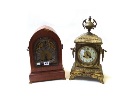 A mahogany cased mantel clock, early 20th century, of navette domed form, with silvered chapter ring and slow/fast subsidiary